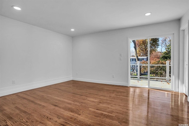 unfurnished room with wood-type flooring