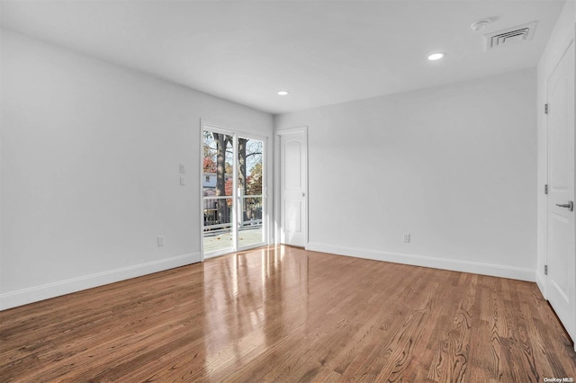 unfurnished room featuring hardwood / wood-style flooring