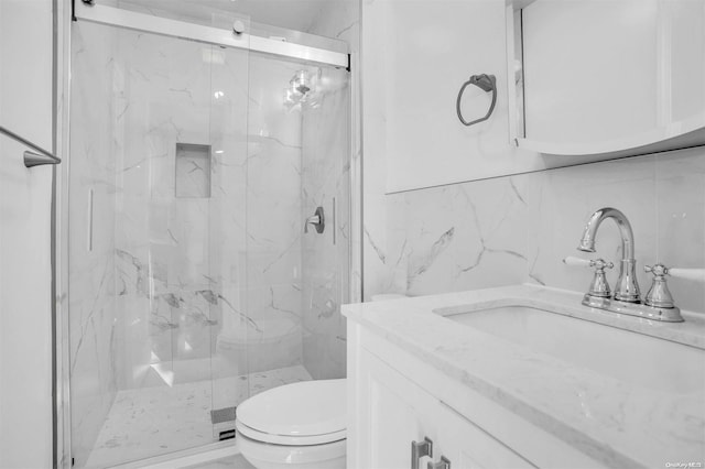 bathroom featuring a shower with shower door, tile walls, and tasteful backsplash