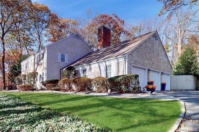 view of side of property featuring a yard and a garage