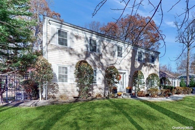 colonial-style house with a front lawn