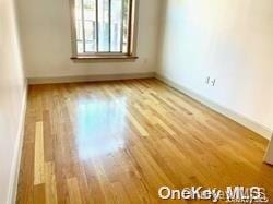 unfurnished room featuring wood-type flooring