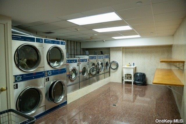 clothes washing area featuring stacked washer / drying machine and washing machine and clothes dryer