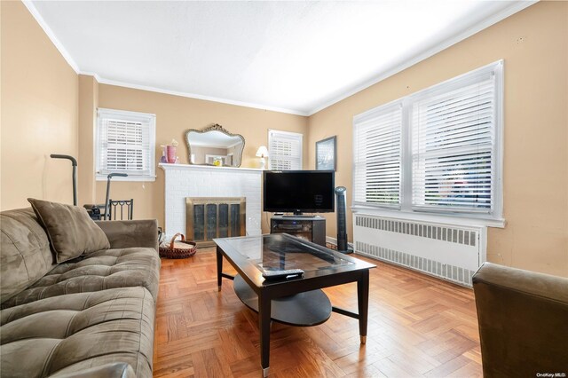 living room with parquet flooring, radiator, and a healthy amount of sunlight