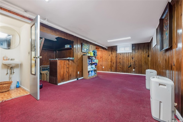 interior space featuring carpet flooring and wood walls