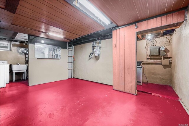 basement with washer / clothes dryer, wood ceiling, and sink