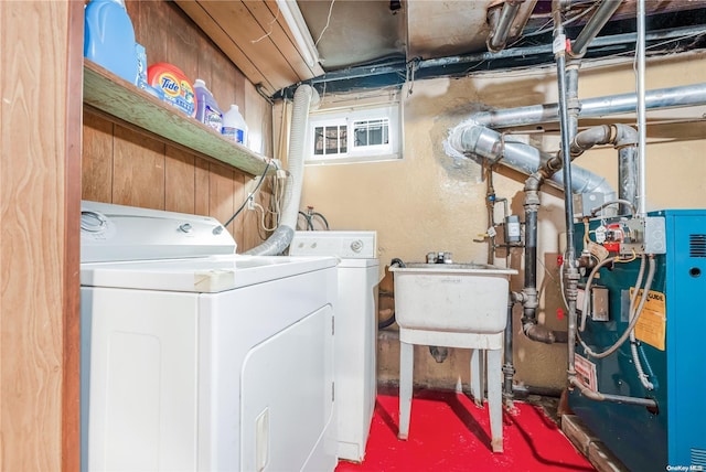 clothes washing area featuring washer and clothes dryer and sink