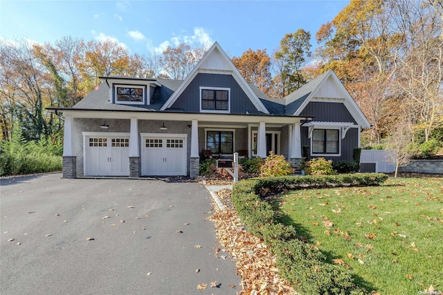 view of front of house with covered porch and a front lawn