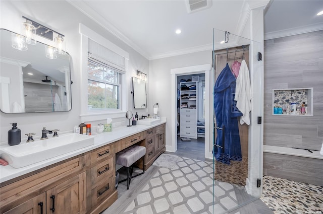 bathroom with a shower, hardwood / wood-style floors, vanity, and ornamental molding