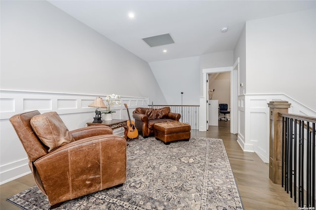 living area with hardwood / wood-style flooring and lofted ceiling