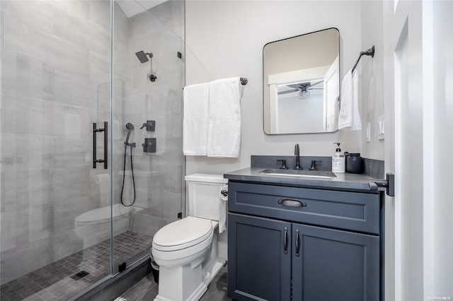 bathroom with walk in shower, vanity, toilet, and ceiling fan