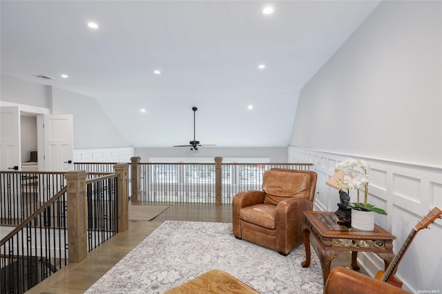 living area with ceiling fan, light wood-type flooring, and lofted ceiling