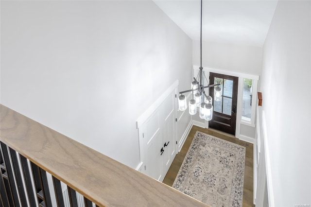 entryway featuring a chandelier, dark hardwood / wood-style floors, and lofted ceiling