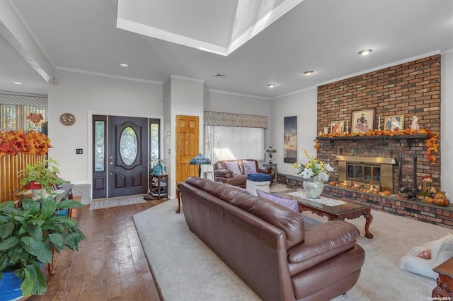 living room with a fireplace, crown molding, and hardwood / wood-style floors