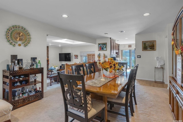 dining room featuring light colored carpet