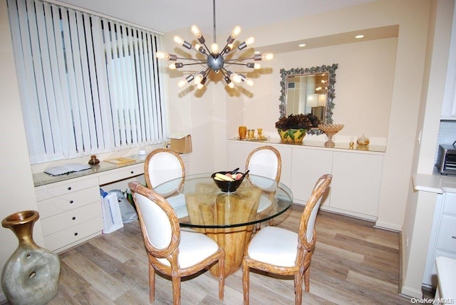 dining space featuring a chandelier and light hardwood / wood-style floors