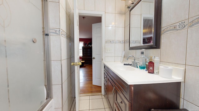 bathroom with vanity, tile patterned floors, and tile walls