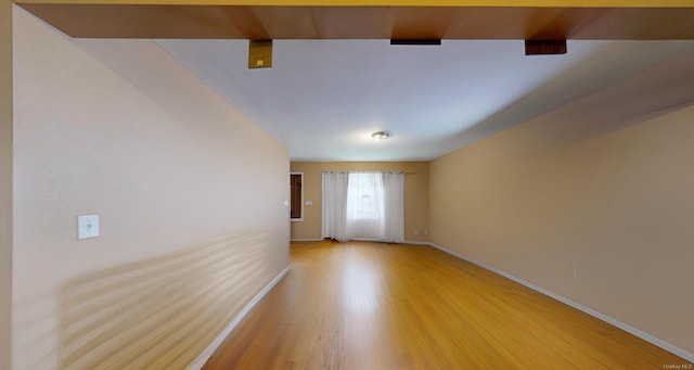 unfurnished room with hardwood / wood-style flooring