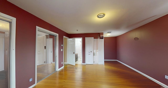 unfurnished bedroom featuring light hardwood / wood-style floors and a closet