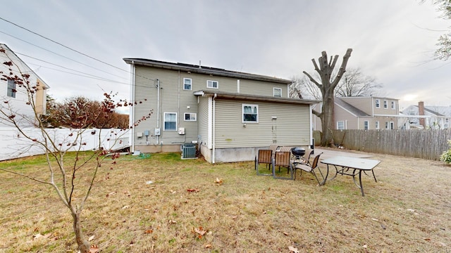 back of property featuring a yard and central air condition unit