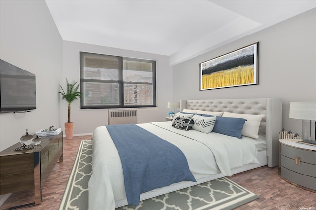 98-22 63rd Dr Unit 5-E, Rego Park, NY 11374 - bedroom with radiator heating unit and wood finished floors