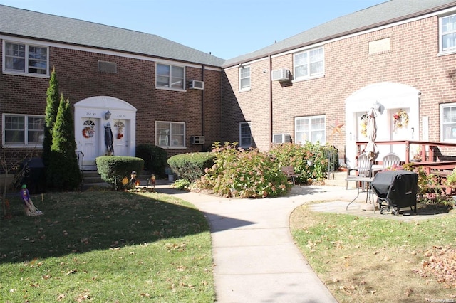 252-51 63rd Ave Unit 5A, Little Neck, NY 11362 - view of front of house featuring a front yard, brick siding, and cooling unit