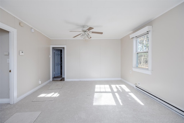 spare room with ceiling fan, crown molding, light carpet, and a baseboard heating unit