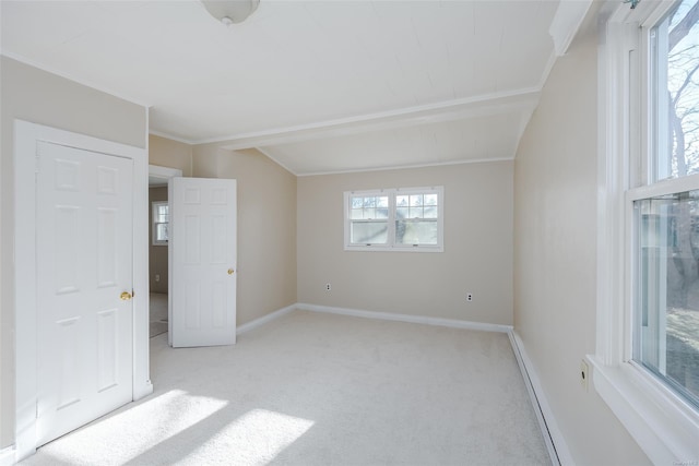 unfurnished bedroom featuring light carpet, multiple windows, and ornamental molding