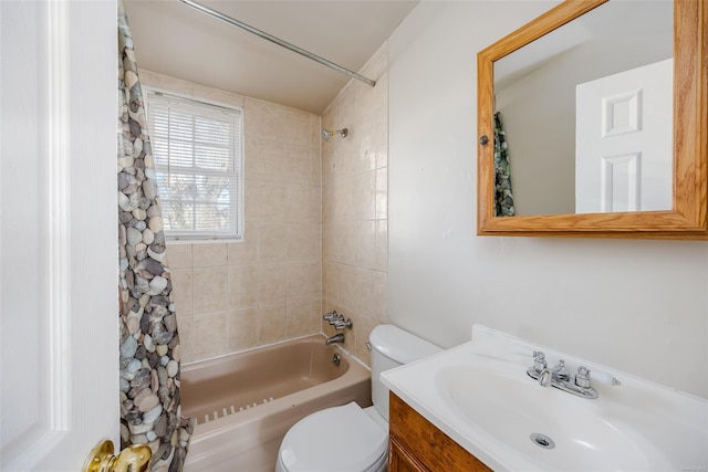 full bathroom with vanity, tiled shower / bath combo, and toilet