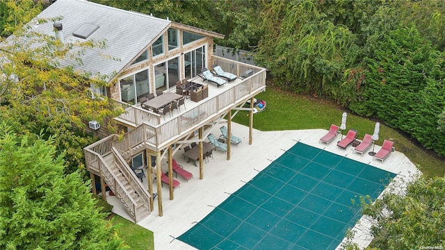 back of house with a deck and a patio area