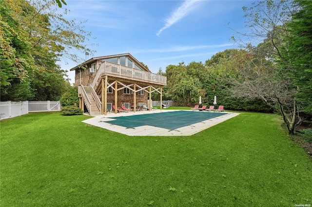 view of swimming pool featuring a patio area, a yard, and a deck