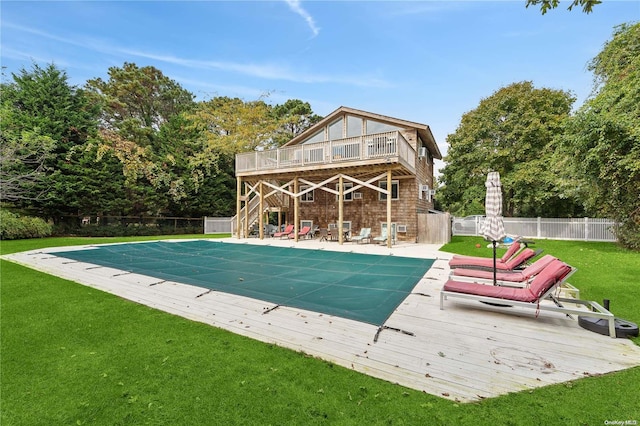 view of swimming pool with a patio area, a yard, and a deck