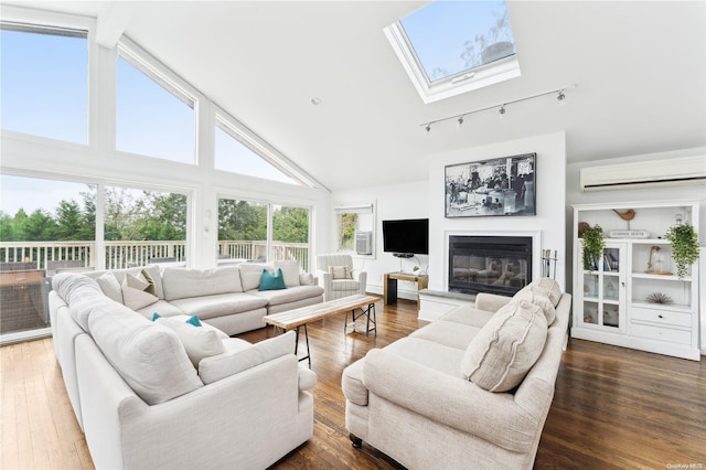 living room with a skylight, a wall unit AC, wood-type flooring, beam ceiling, and high vaulted ceiling