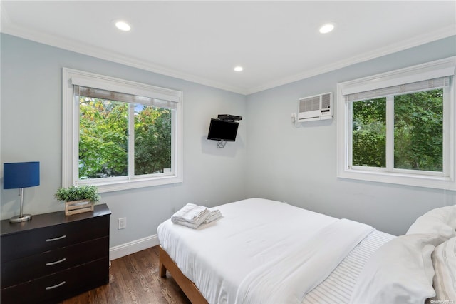 bedroom with a wall unit AC, multiple windows, dark wood-type flooring, and crown molding