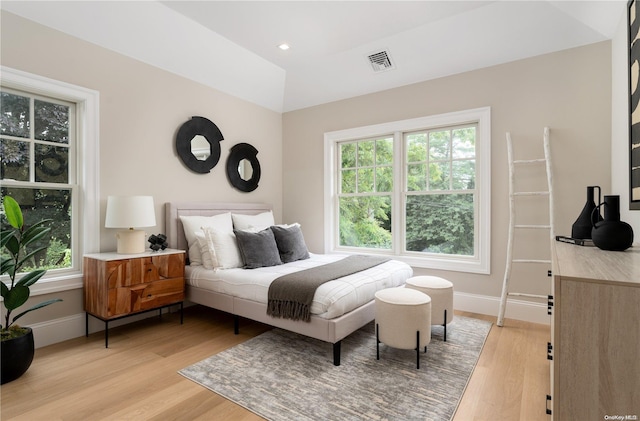 bedroom featuring light hardwood / wood-style flooring and multiple windows