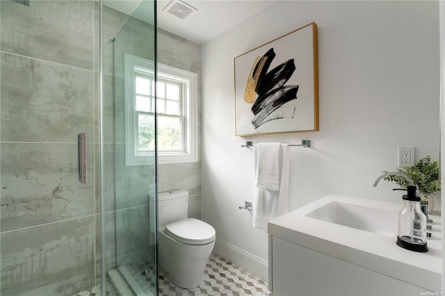 bathroom with vanity, an enclosed shower, and toilet