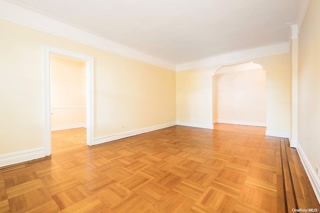 unfurnished room featuring crown molding and light parquet floors