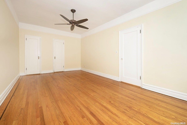 spare room with light hardwood / wood-style flooring, ceiling fan, and crown molding