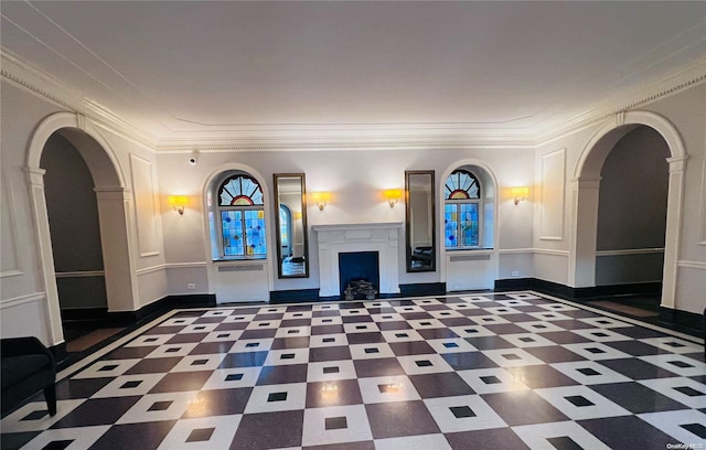 unfurnished living room featuring crown molding