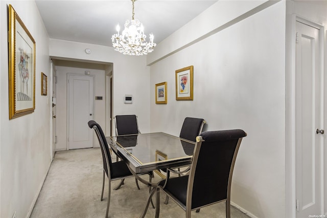 dining room featuring a notable chandelier and light carpet