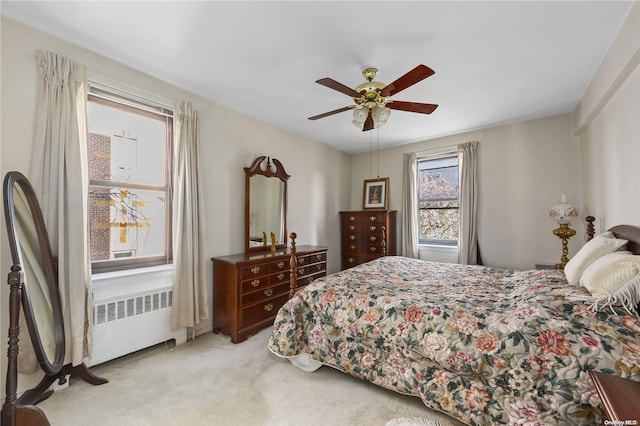 carpeted bedroom featuring ceiling fan and radiator heating unit