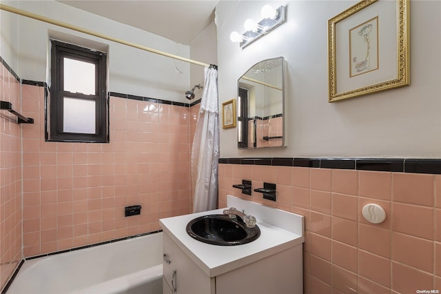 bathroom featuring shower / tub combo with curtain, vanity, and tile walls