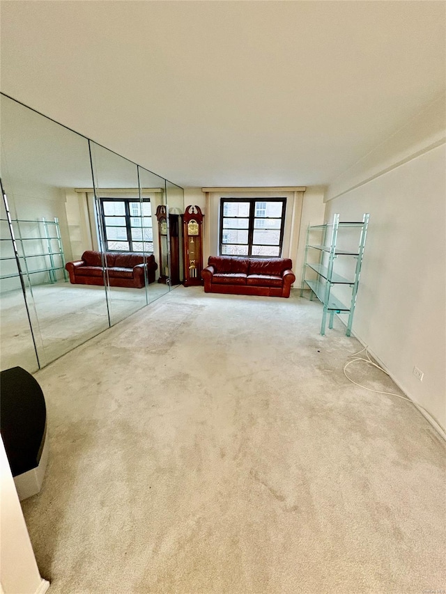 unfurnished room featuring plenty of natural light and carpet