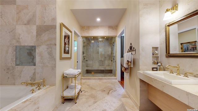 bathroom with sink and independent shower and bath