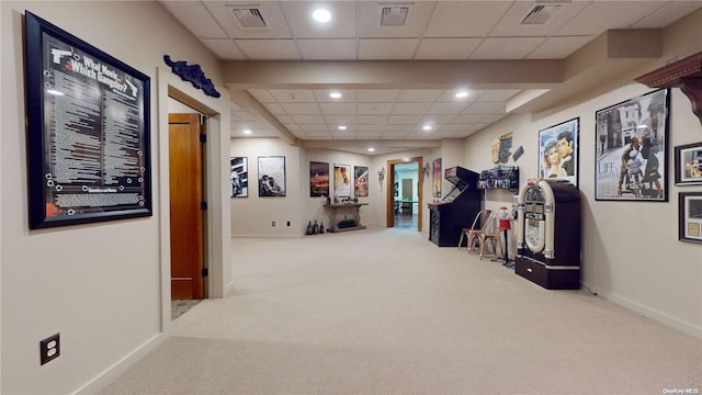 corridor with carpet and a paneled ceiling