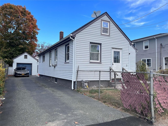 view of front of property with a garage and an outdoor structure