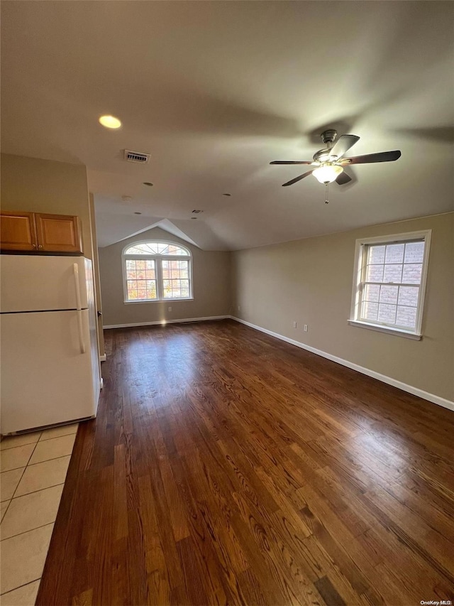 interior space featuring ceiling fan, dark wood-type flooring, and lofted ceiling