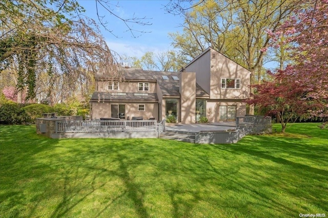 rear view of house featuring a lawn