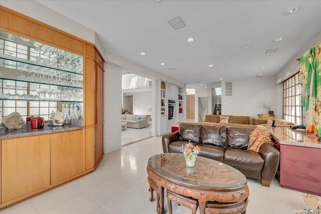 living room featuring bar area and plenty of natural light