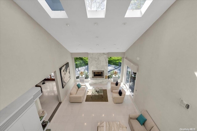 unfurnished living room featuring light tile patterned floors, a high ceiling, and a premium fireplace